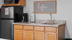A kitchen with a microwave, toaster, refrigerator, and a framed inspirational quote on the wall. - Meadow View | King Suite for 2 | Wears Valley (Sevierville)