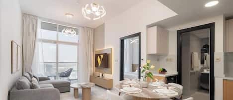Luxury Apartment, Balcony, City View | Living area | 65-inch Smart TV with cable channels