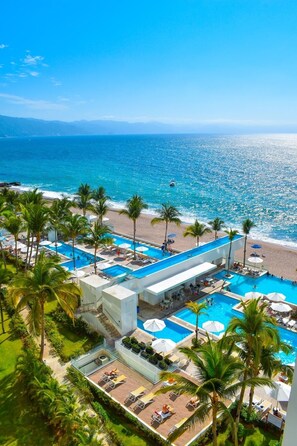 A resort with a pool area, beach, and ocean view. - Beachfront Studio at Harbor 171, Puerto Vallarta – Ocean Views & Pool + Beach! (Puerto Vallarta)