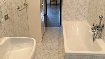A bathroom with a sink, bathtub, and toilet.