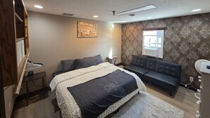 A bedroom with a bed, a sofa, a desk, and a window. - Big space on Deadwood`s Main Street! (Deadwood)