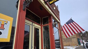 A building with a sign reading 'The Nugget Watering Hole.' - Big space on Deadwood`s Main Street! (Deadwood)