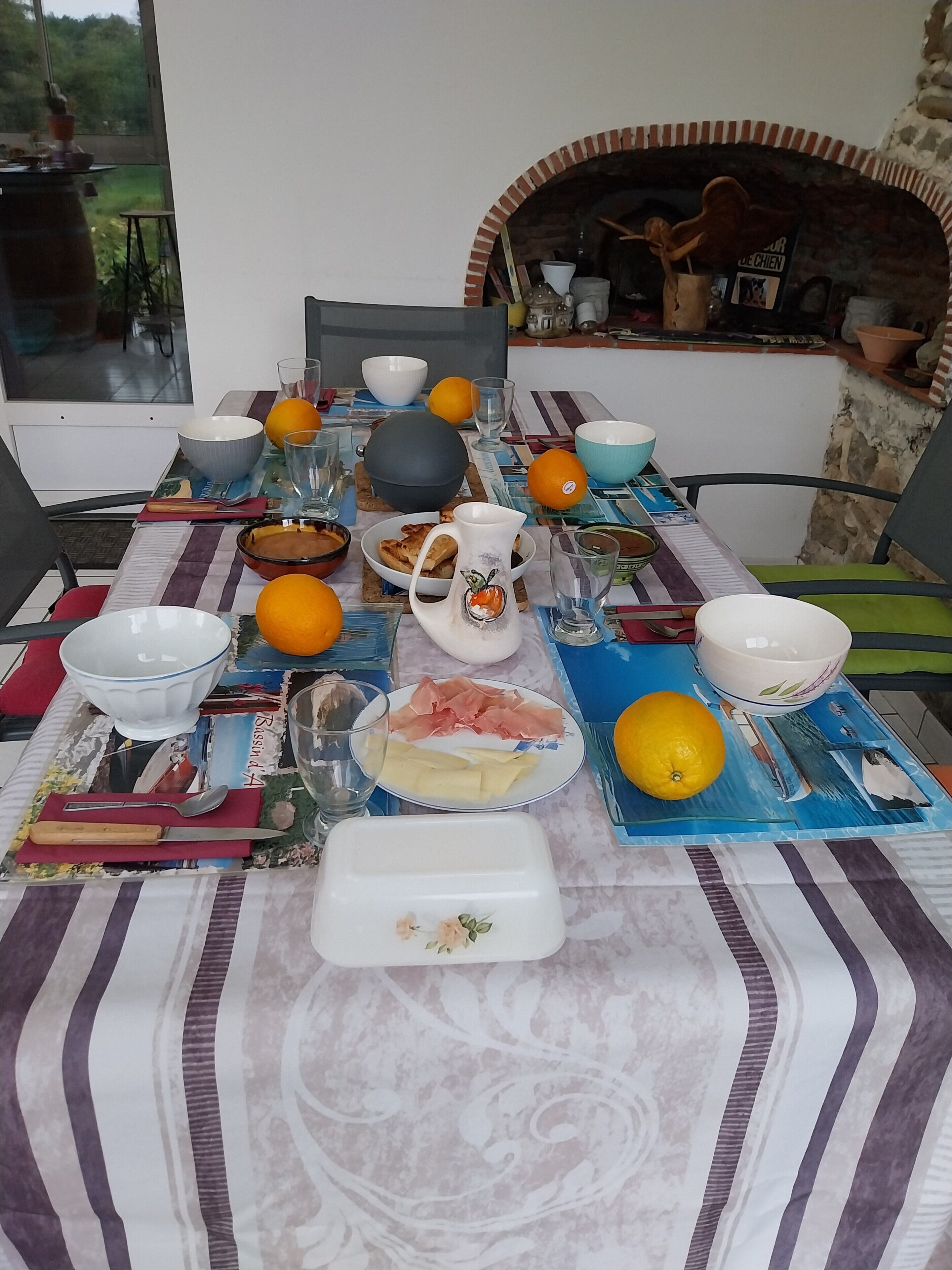 A dining table set with various dishes, including plates of food, bowls, and glasses.