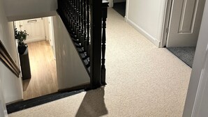 A carpeted staircase with a handrail, leading to a room with a bed and a nightstand. - Modern 3 bed Home by Glasgow Airport (Paisley)