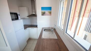 Standard Apartment, 1 Bedroom, Terrace, Beachfront | Private kitchen | Microwave, highchair