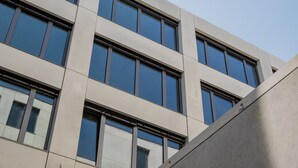 A modern building with a grid of windows and a clean, minimalist facade. - Nena Apartments Moritzplatz by LESA (Berlin)
