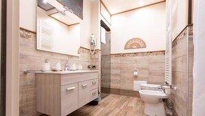 A modern bathroom with a wooden vanity, a glass shower enclosure, and a separate toilet area. - Antica Piacenza (Piacenza)
