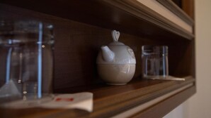 A shelf with a teapot, two glasses, and a tissue. - Antica Piacenza (Piacenza)