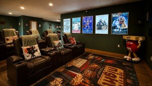 A home theater with leather recliners, a large poster rug, and movie posters on the wall. - Moonlight Mountain Lodge at Camelback Mountain! (Tannersville)