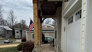 A residential garage with a ramp leading to the entrance, a mailbox, and a flag. - Handicapped- Accessible, Family-Friendly Home near UVA (Charlottesville)