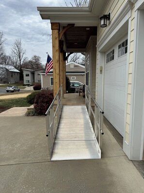 A residential garage with a ramp leading to the entrance, a mailbox, and a flag. - Handicapped- Accessible, Family-Friendly Home near UVA (Charlottesville)
