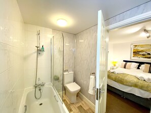 A modern bathroom with a glass-enclosed shower, a bathtub, and a toilet. - Number 1 Marina Court (Torquay)
