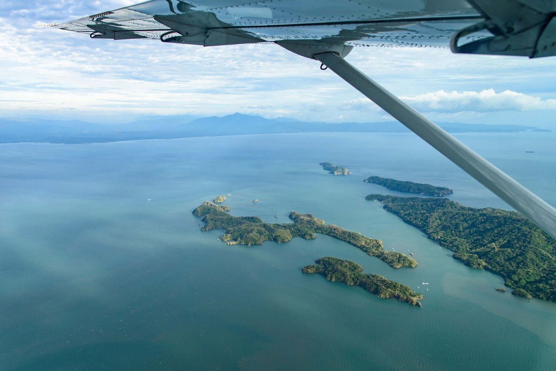 An aerial view of a coastal area with multiple islands surrounded by water.
