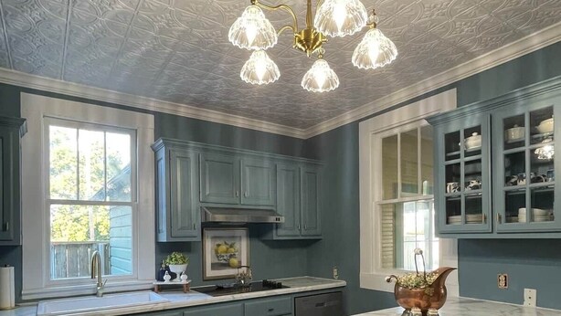 A kitchen with a marble island, pendant lights, and a view of the outdoors. - The Martin House | Family Getaway Near Shawnee (Elizabethtown)