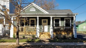 A two-story house with a porch, a front door, and a mailbox. - Renovated Spacious Home Near Downtown, Sleeps 10 (Richmond)