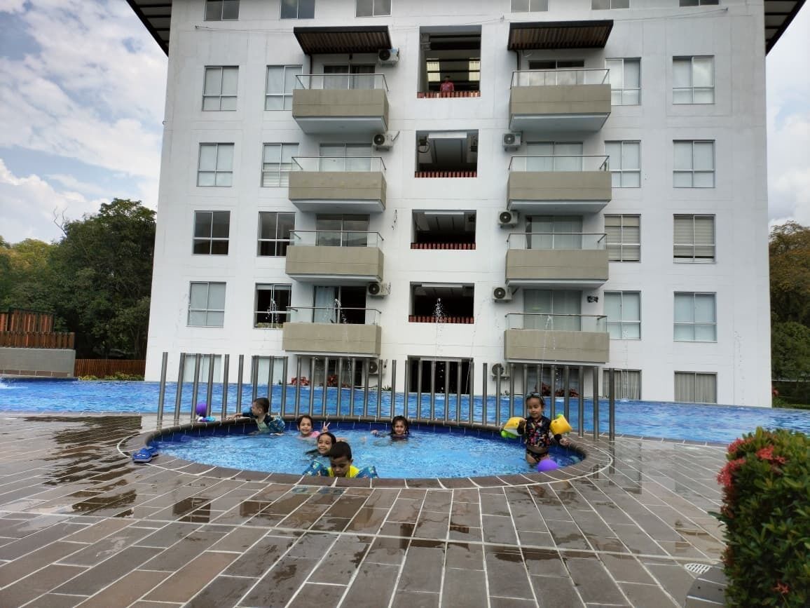 A multi-story building with a swimming pool area.