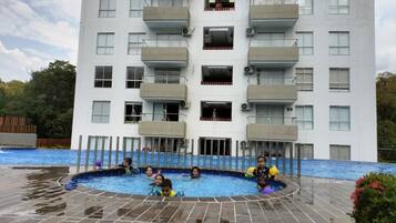 A multi-story building with a swimming pool area.