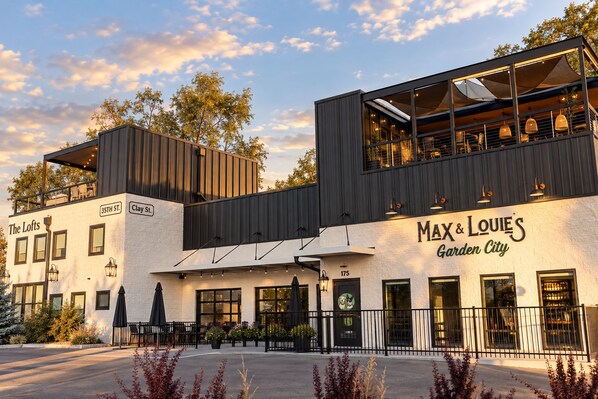 A modern building with a restaurant named 'Max & Louie's Garden City' on the ground floor. - The Lofts @35th and Clay - Loft A (Garden City)