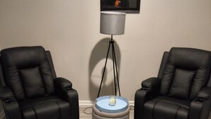 Two black leather chairs, a small round table with a blue top, and a floor lamp with a grey shade. - Private Studio near Atlanta ,20 min to Mercedes-Benz Stadium, Separate Entrance (Lithia Springs)
