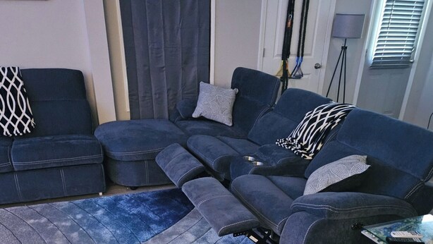 A living room with a sectional sofa, a coffee table, and a rug. - Private Studio near Atlanta ,20 min to Mercedes-Benz Stadium, Separate Entrance (Lithia Springs)