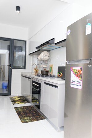 A modern kitchen with white cabinetry, a stainless steel refrigerator, and a dishwasher. - 2Bedroom city views and workspace||16th floor in Westlands (Nairobi)