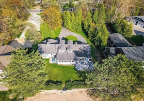 A residential property with a large house, a garage, and a driveway.
