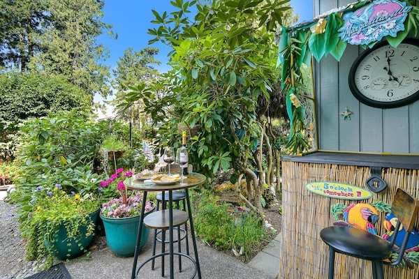 Lush garden patio with cozy seating and vibrant greenery
