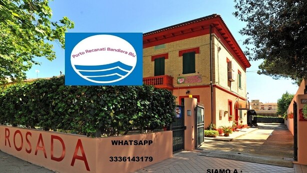 A building with a sign reading 'Casa Rosada' and a WhatsApp contact number. - PortoRecanati Zimmer (Porto Recanati)