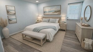 A bedroom with a bed, bedside tables, a bench, a dresser, and artwork on the walls. - Waterfront Matlacha views! 2/2 Heated Pool Home (Matlacha)