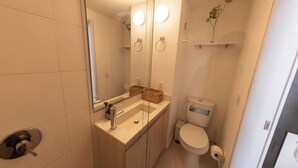 A bathroom with a toilet, sink, and mirror. - Artistic Hub / Gourmet District Loft, Chapinero Alto (Bogotá)