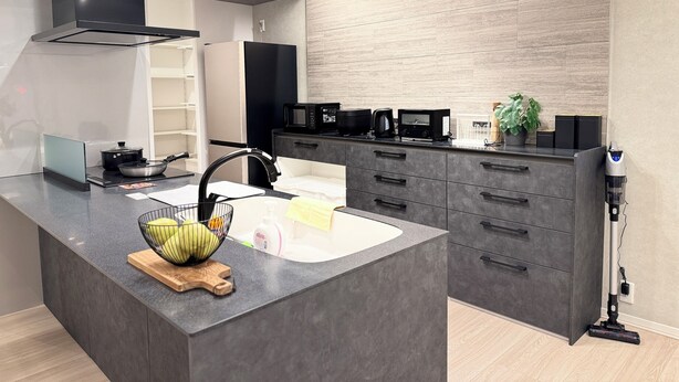 A modern kitchen with a central island, built-in appliances, and a sleek design. - Akikawa Ozu 1 | 15 min to TSMC | Entire 3LDK House | Up to 6 Guests (Ozu)