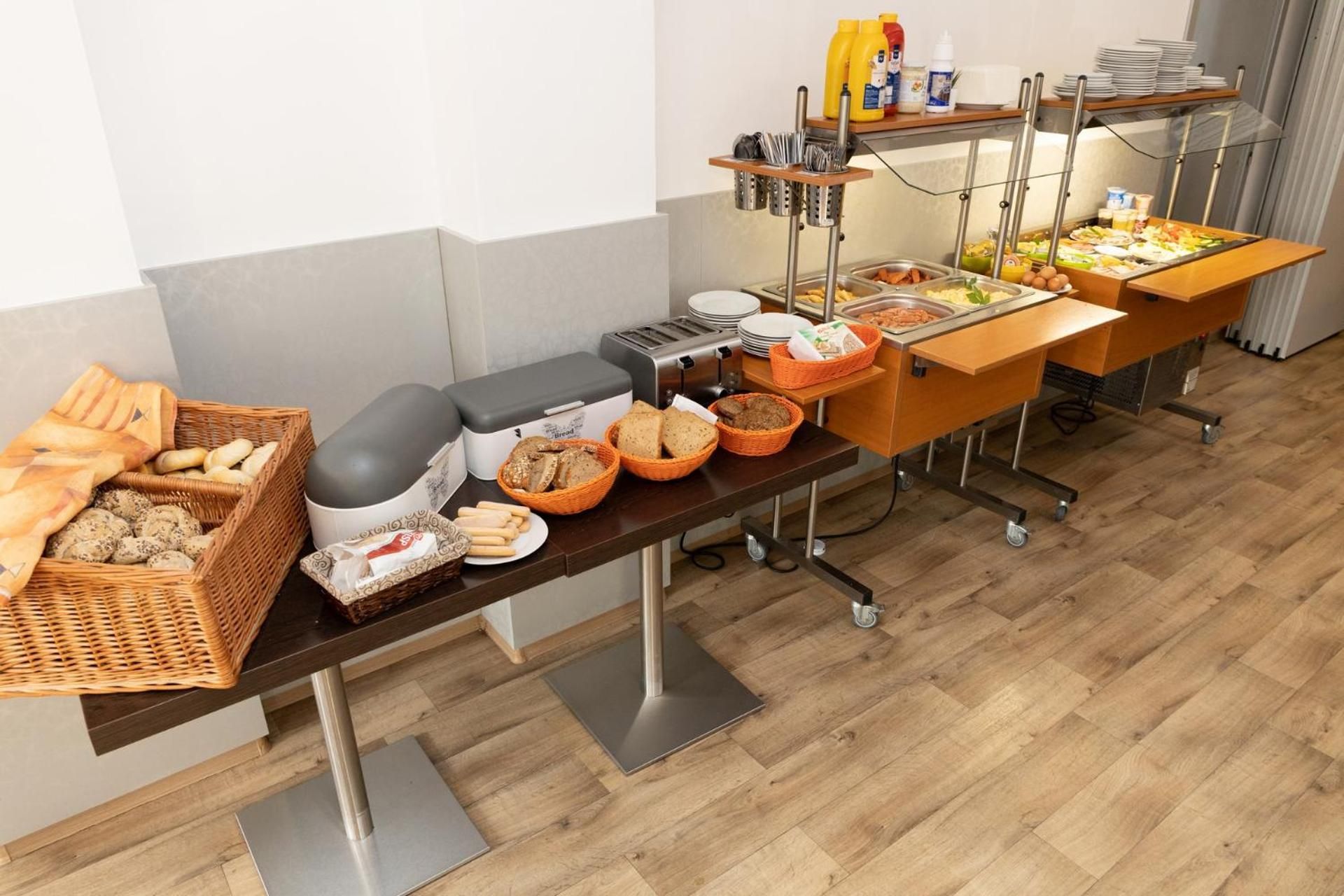 A buffet setup with various food items and condiments.
