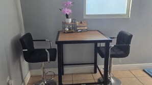 A small room with a table and two chairs, a potted plant, and a window. - #15 Guest house Midtown stadium B (Tampa)
