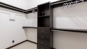 A compact walk-in closet with a metal rack, a shelf, and a set of drawers. - Relax in Style – Gated 3BR/2BATH Close to Mall & Restaurants - Centrally Located (McAllen)