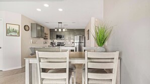 A modern kitchen with grey cabinets, stainless steel appliances, and a central island. - Sunset Ridge  Private Patio, Cliffside Lake Views (Lake Ozark)