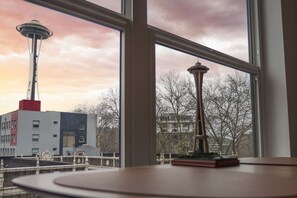 Blick durch ein Fenster auf die Space Needle, mit einem Modell derselben Struktur auf einem Tisch.