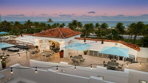 A rooftop terrace with outdoor seating, string lights, and a view of the ocean. - Miami Beach Studio – Walk to South Beach & Art Deco District (Miami Beach)