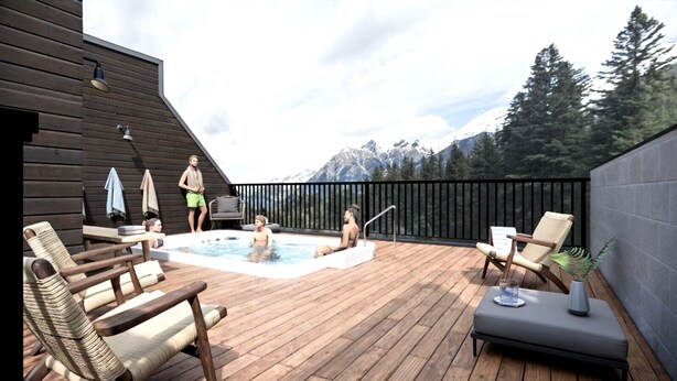 Een houten terras met een jacuzzi, lounge stoelen en uitzicht op bergen.