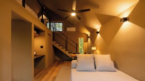 A bedroom with a bed, a staircase, a ceiling fan, and a window. - Everlake Georgia (Covington)