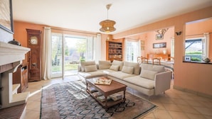 A living room with a sofa, coffee table, and bookshelves.