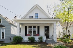A two-story house with a front porch, a chimney, and a small front yard. - The Single Barrel - Deck, Fire Pit, Hot Tub, Games (Louisville)