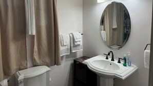 A bathroom with a toilet, sink, mirror, and towel rack. - Private Writers Room at SaddleRock Ranch in Heart of Sedona (Sedona)