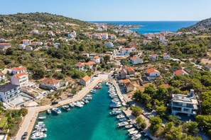 An aerial view of a coastal town with a marina, houses, and hilly terrain. - Villa Verde Ra anj With Heated Pool (Rogoznica)