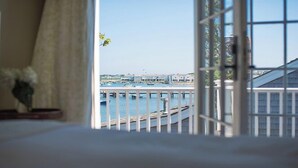 A view from a room with a large window overlooking a marina with boats and buildings. - 2.5 bedroom, 2.5 bathroom (Nantucket)