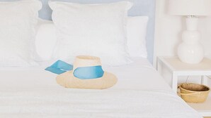 A neatly made bed with white bedding, a blue headboard, and a bedside lamp. - 2 bedroom, 2.5 bathroom (Nantucket)