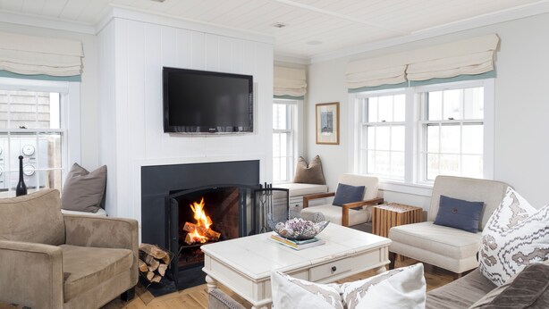A living room with a fireplace, a television, and a sofa.
