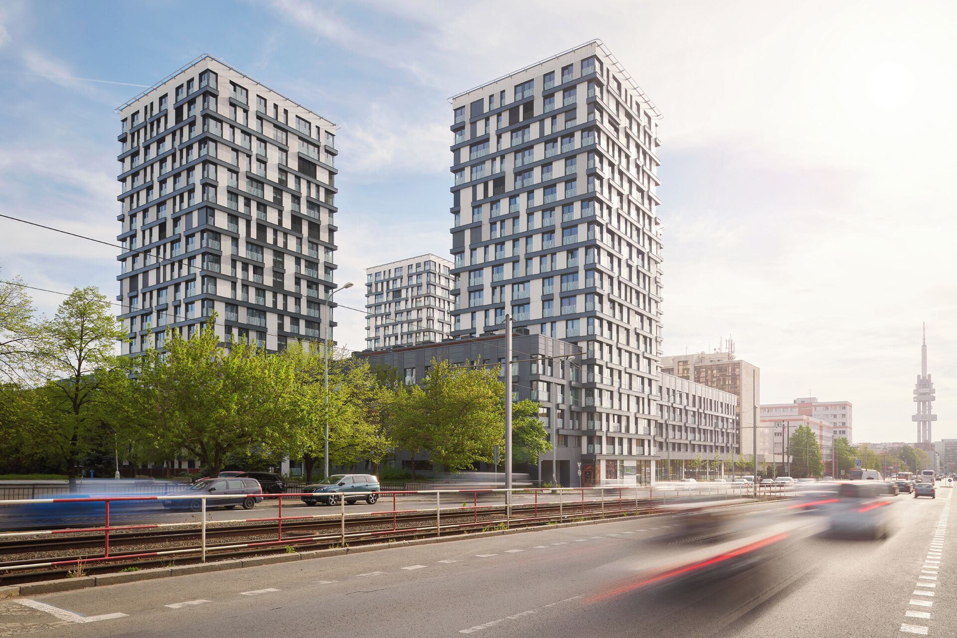 A modern high-rise building with multiple floors, large windows, and a flat roof.