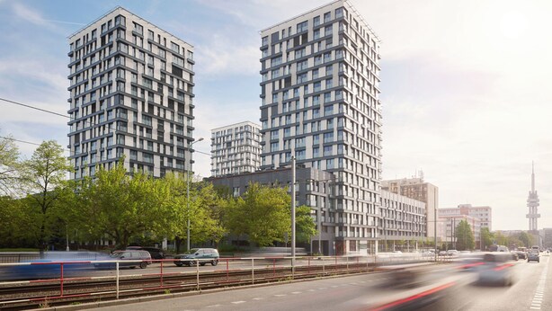 Ein modernes Hochhaus mit mehreren Stockwerken, großen Fenstern und einem flachen Dach.