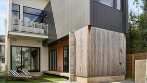 A modern two-story house with a swimming pool, a balcony, and a well-maintained lawn. - Modern House, walk to French Quarter or the street car is a block away! (New Orleans)