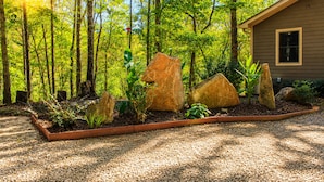 A house surrounded by a forest with a gravel path and large rocks in the garden. - Valley View 2/2! Pool Table! Near Helen! (Clarkesville)